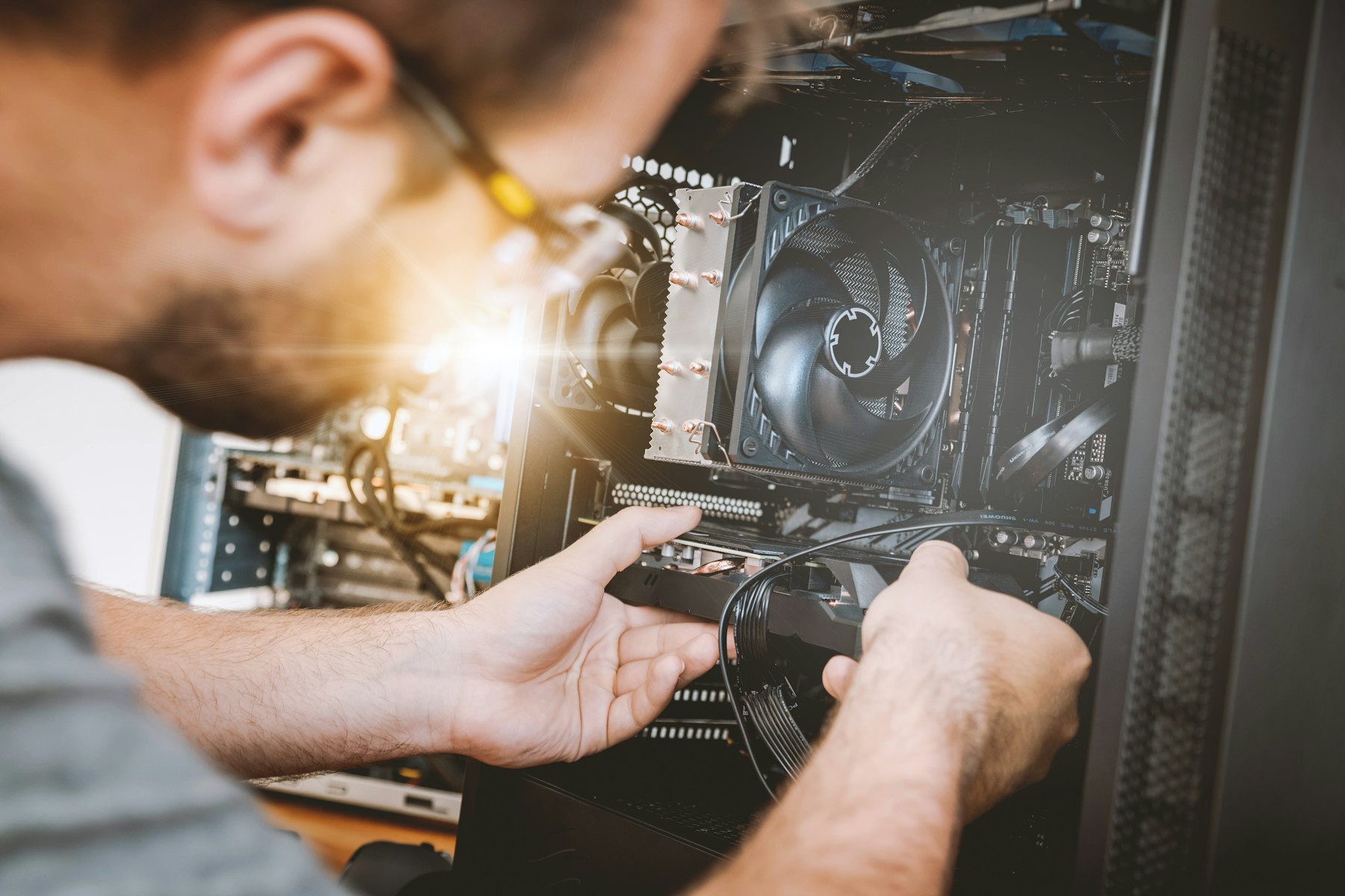 A person installing a graphics card into a computer