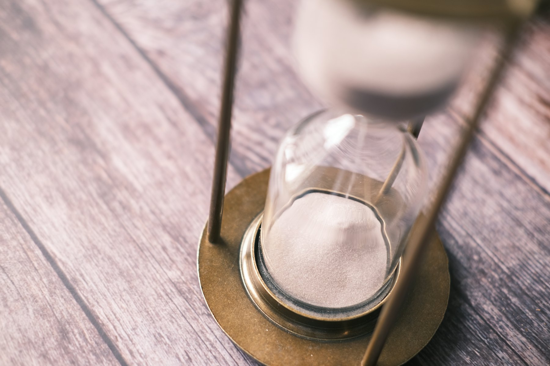 An hourglass on a wooden table